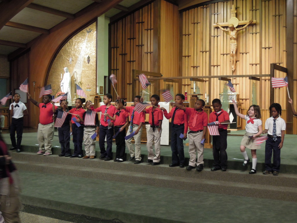 St Joseph the Provider School children waving American flags in church