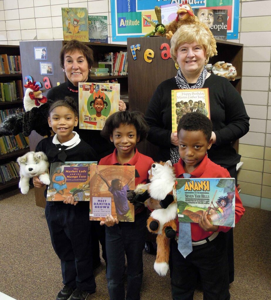 St Joseph the Provider School librarians and students holding books