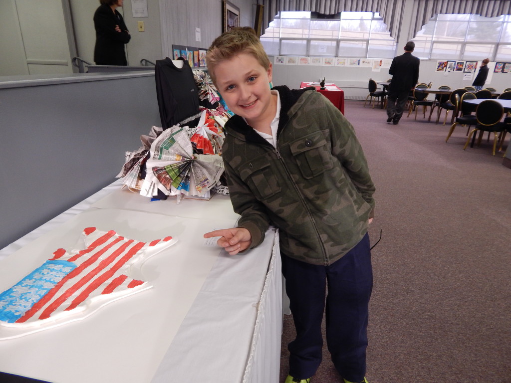 Student next to art project of the United States of America